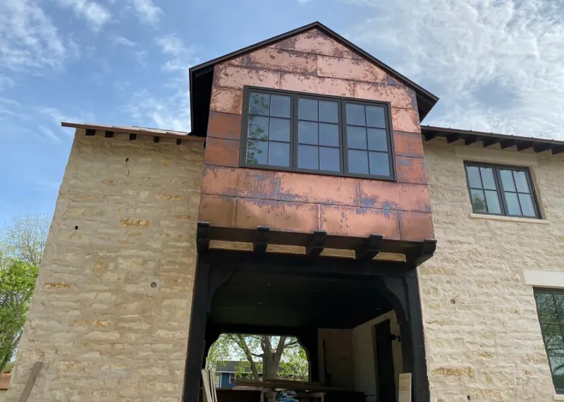 Copper metal panel facade on a stone building for Metal Roof Coating in Spearfish